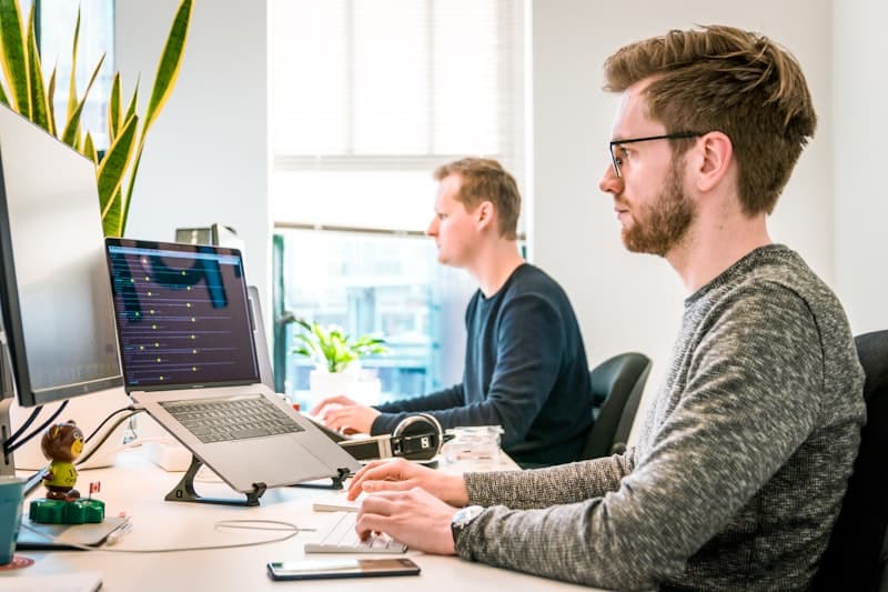 Developers working at desks in an open office environment